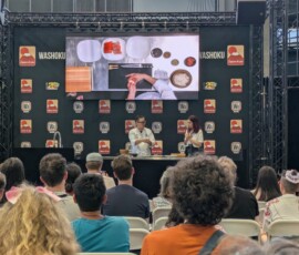 Un chef couronné qui malaxe délicatement un sushi au saumon
